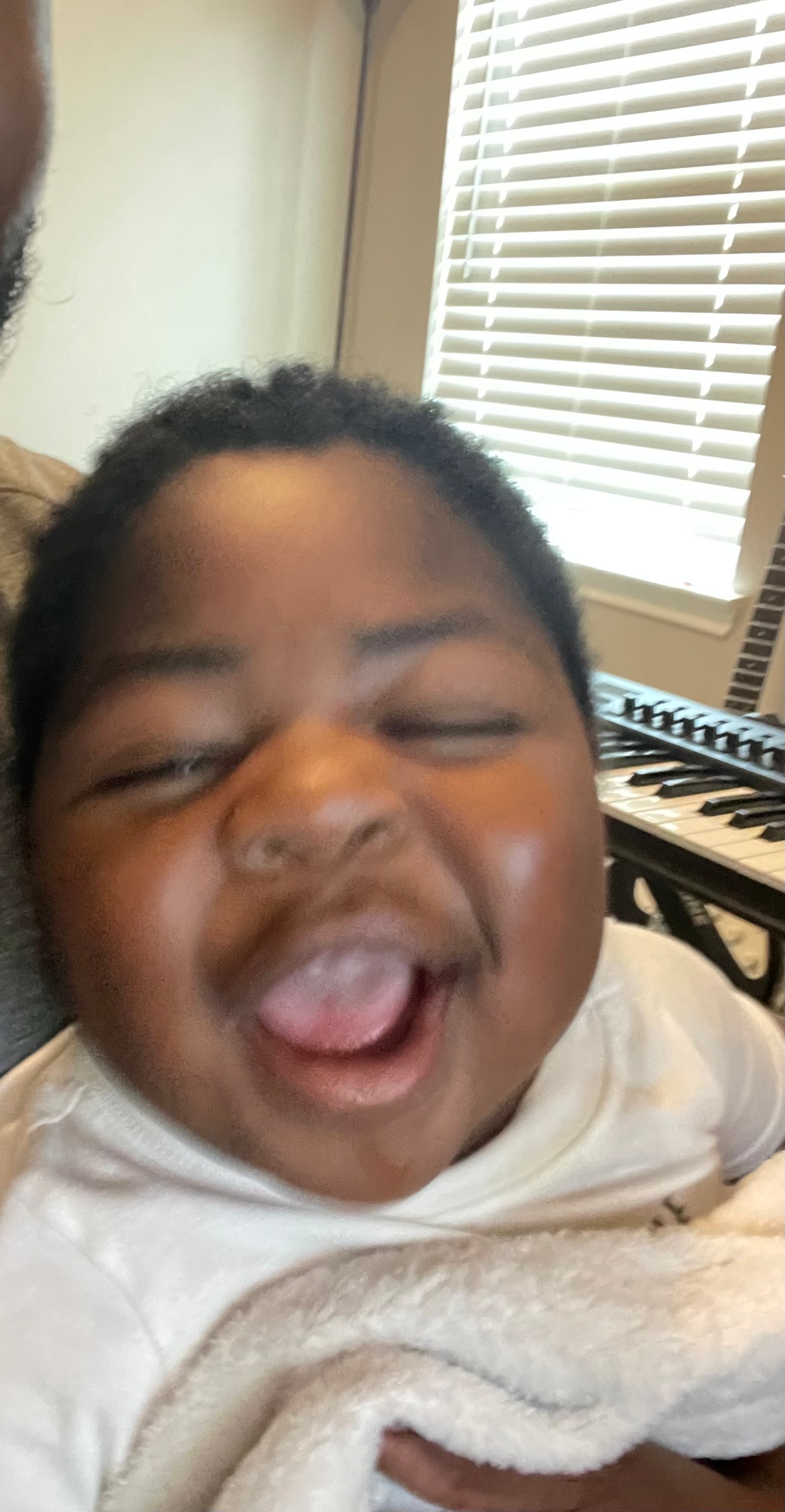 Myles laughing with a piano keyboard in the background