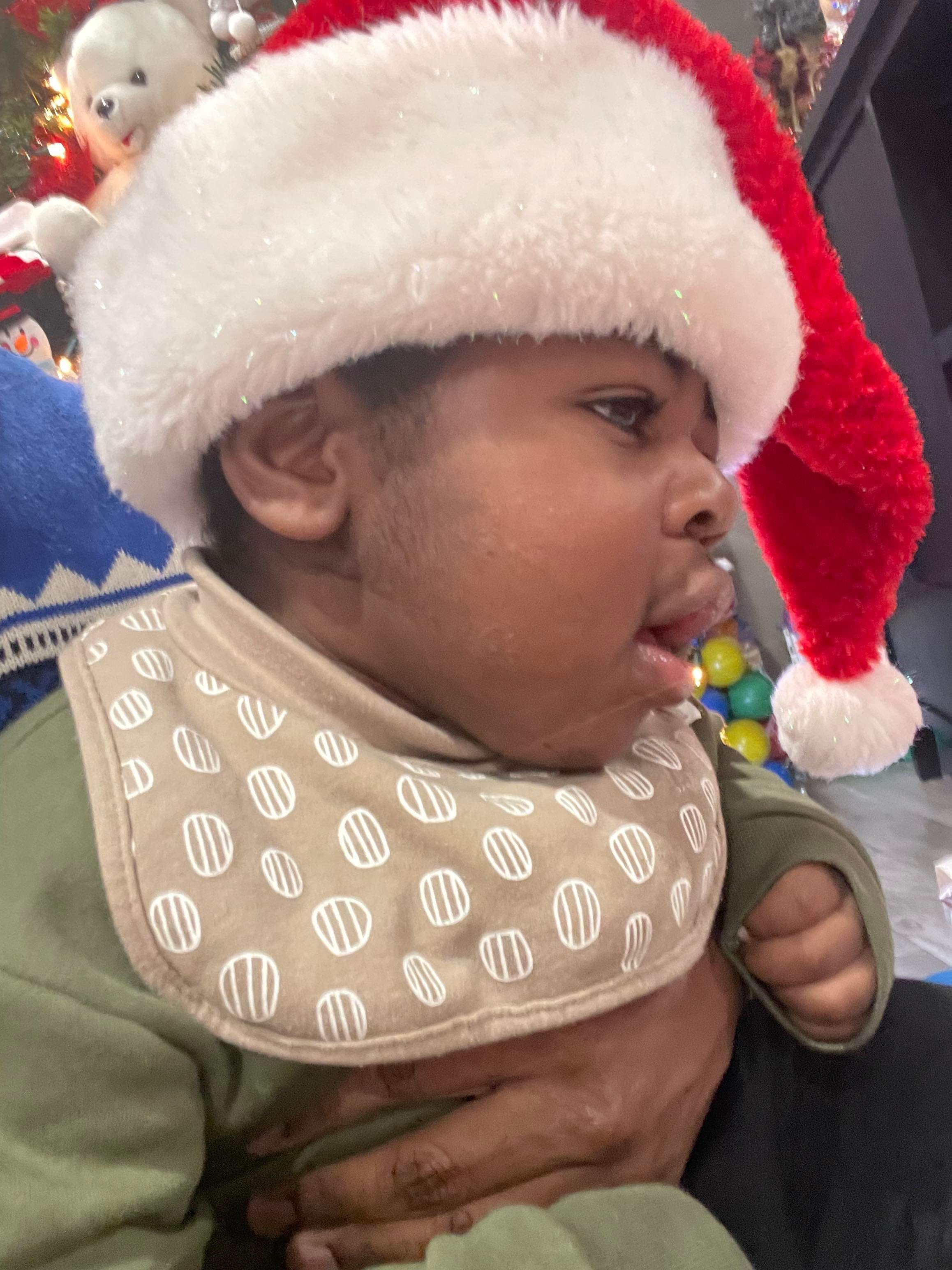 Myles wearing a Santa hat at Christmas
